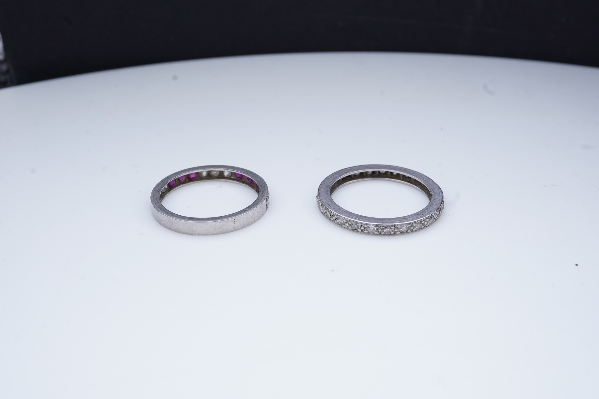 A diamond eternity ring and a ruby and diamond half eternity ring, mid 20th century